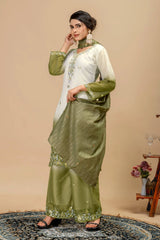 Woman wearing a green and white traditional outfit with a beige background