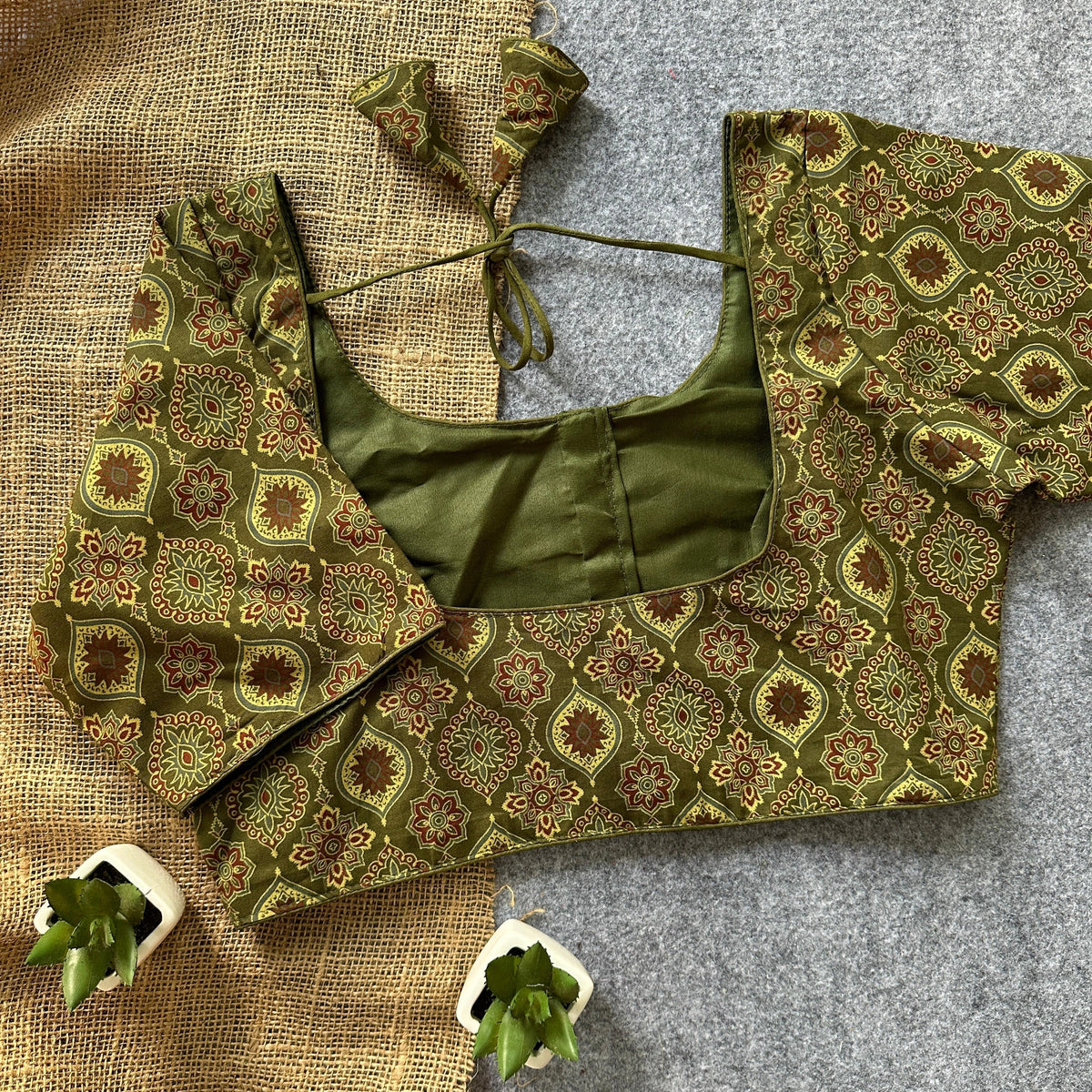 Olive green cotton blouse with handcrafted embroidery and round neckline