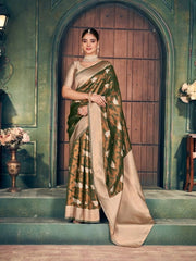 Woman in a traditional saree standing in an elegant indoor setting with decorative elements.