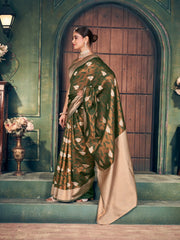 Woman in a traditional saree standing in front of a wooden door with a green wall.