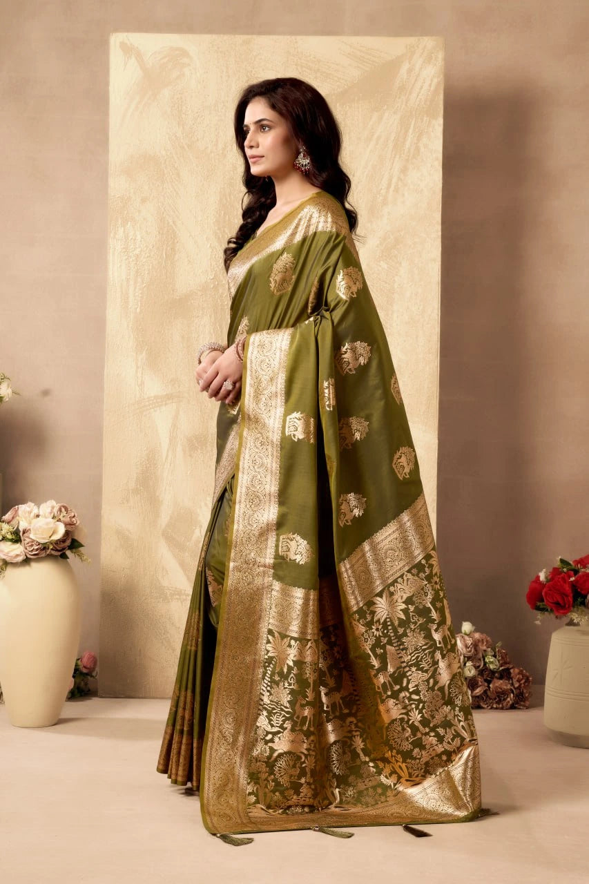 Woman wearing a green saree with gold patterns against a neutral background