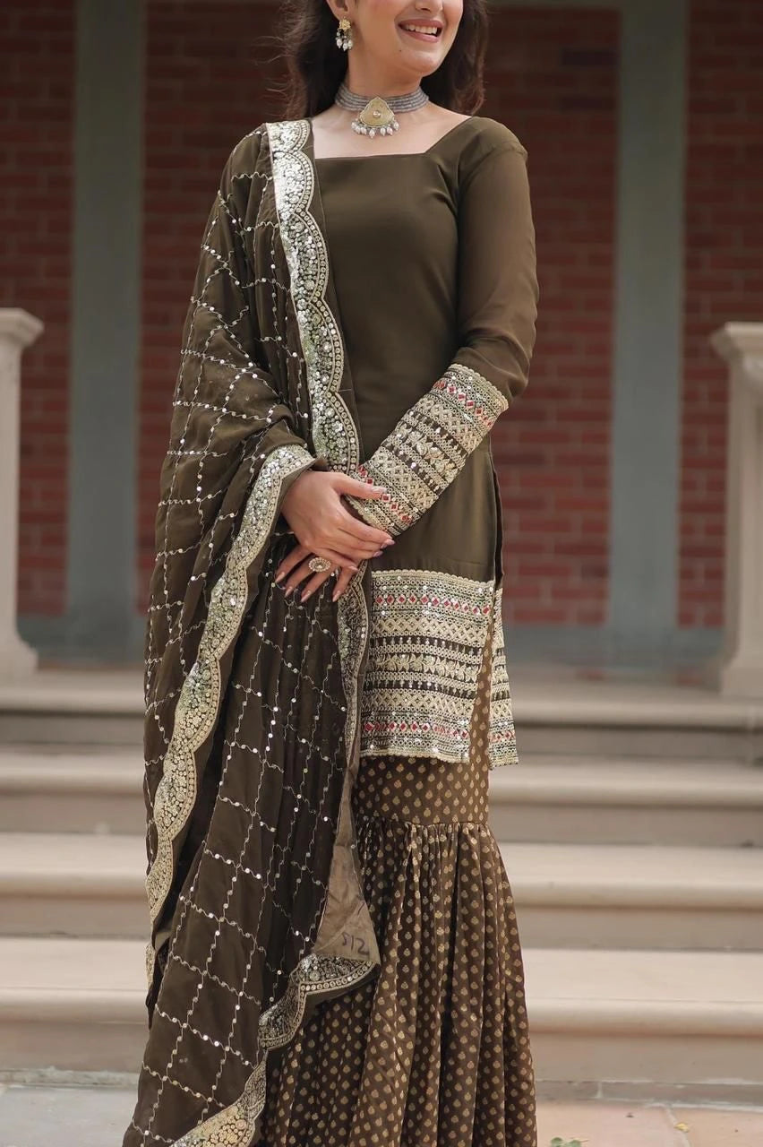 Woman wearing a traditional brown outfit with a matching dupatta in an outdoor setting.