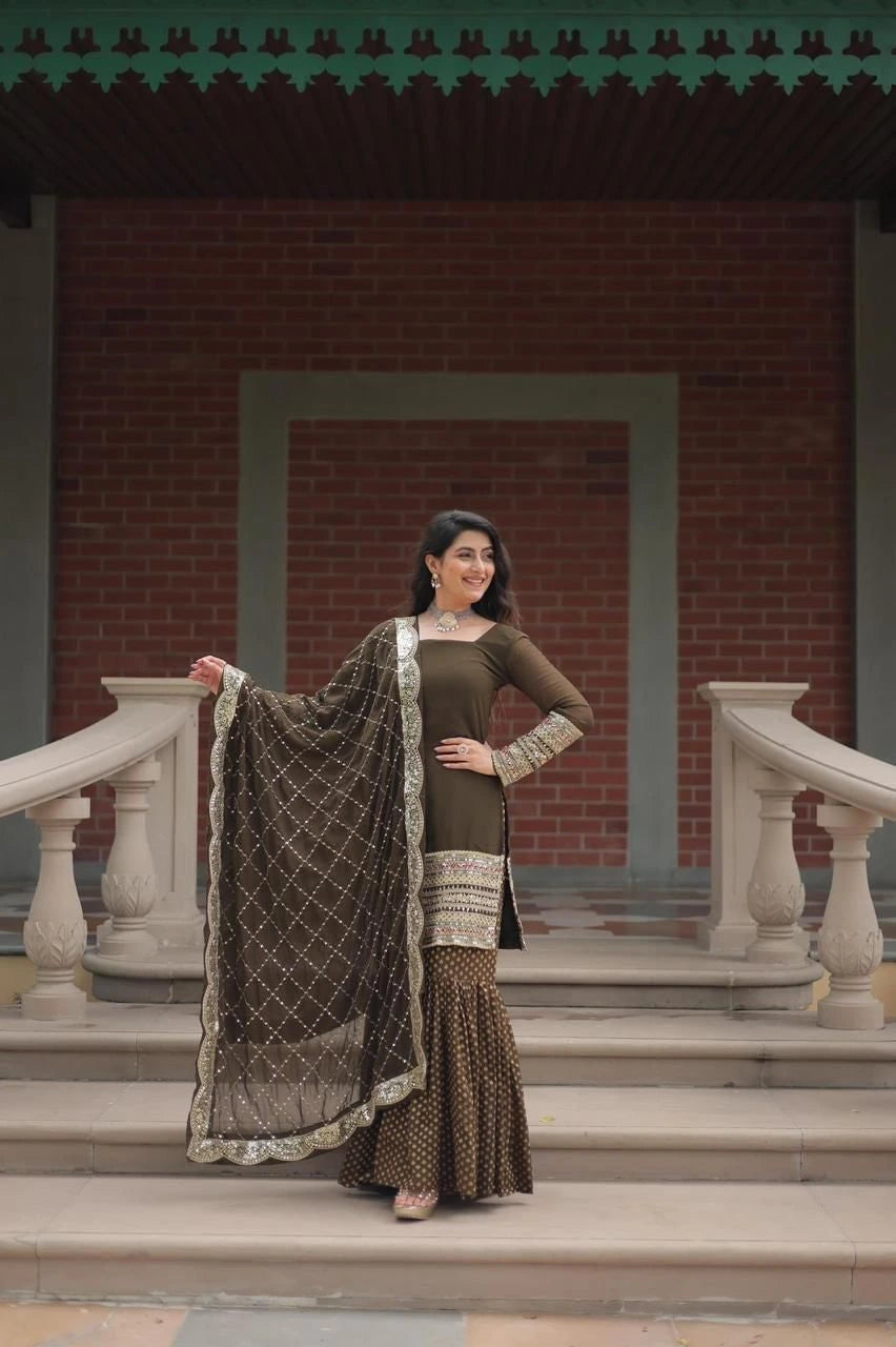 Woman in traditional attire standing on steps with a brick wall background