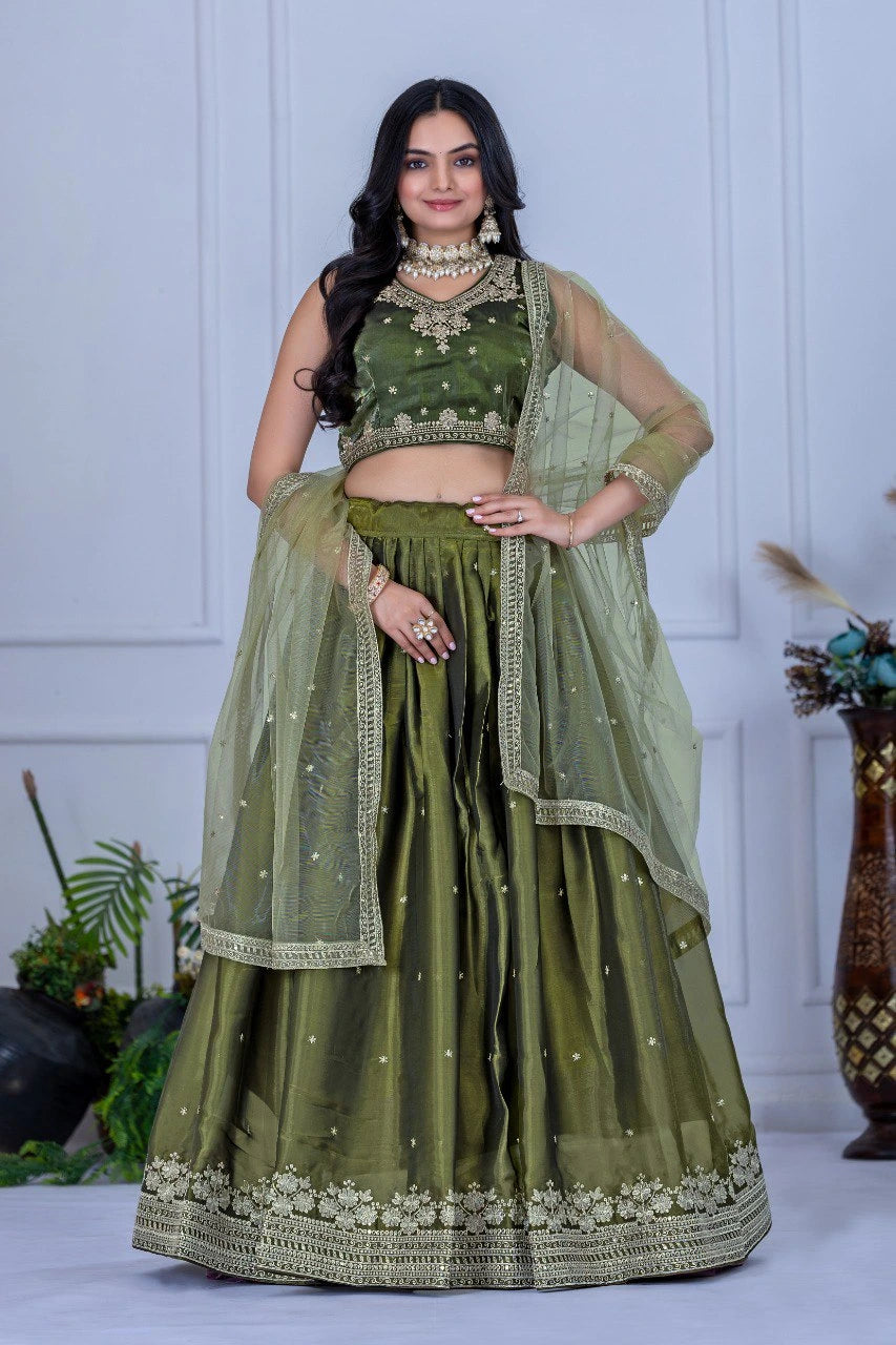 Woman wearing a green traditional outfit with a white background