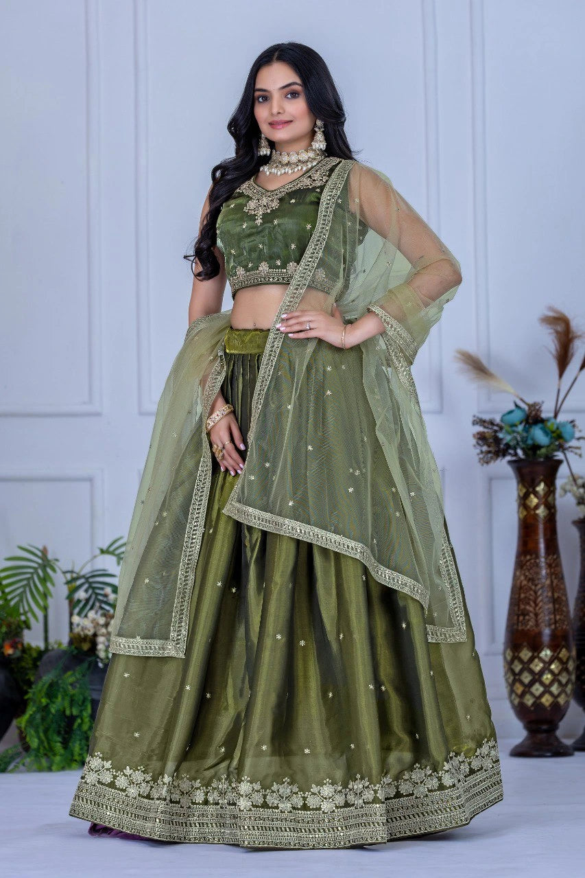 Woman wearing a green traditional outfit with a white background