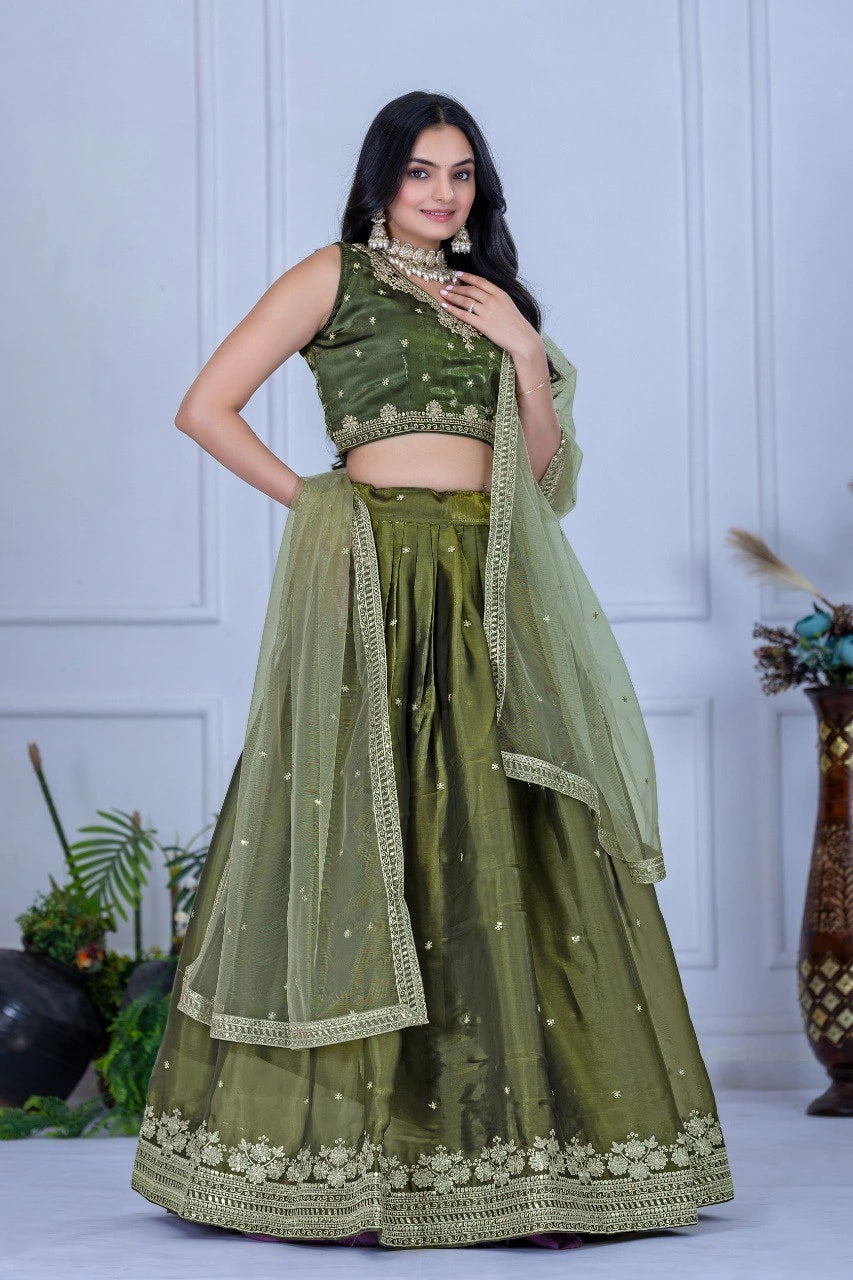 Woman wearing a green traditional outfit with a white background