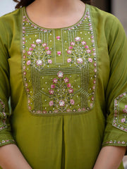 Green embroidered garment with pink flowers on a plain background