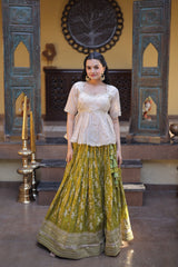 Woman in a traditional outfit standing in a decorated room with decorative elements.