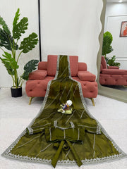 Green embroidered fabric with a decorative pattern on a white background