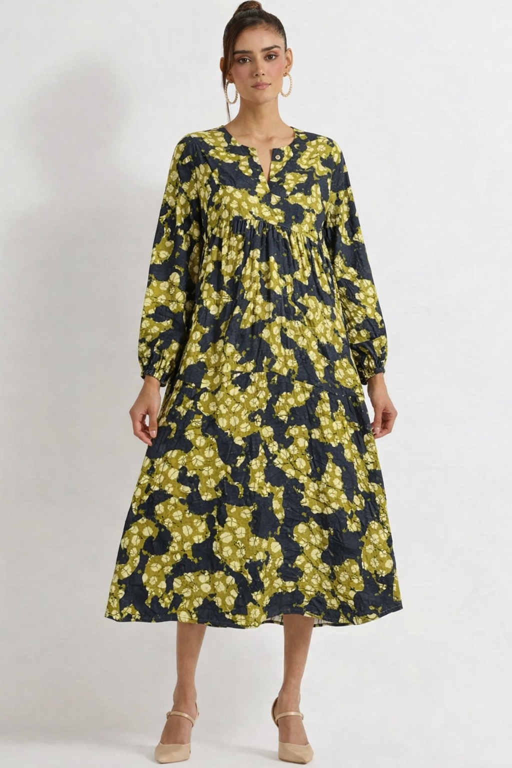 Woman wearing a floral dress with long sleeves on a white background