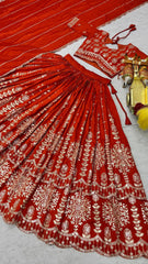 Flat lay of full orange sequins embroidered lehenga set with choli and dupatta