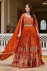 Orange sequins embroidered vichitra lehenga, front standing view with choli and matching dupatta