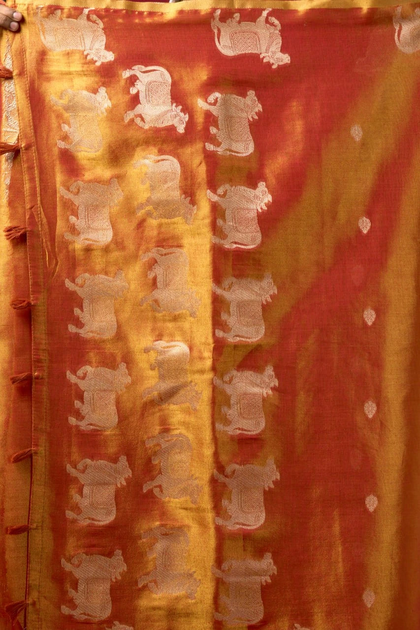 Textile with elephant patterns on a red and orange background