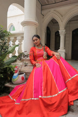 Woman in a traditional outfit sitting on steps with decorative elements in the background