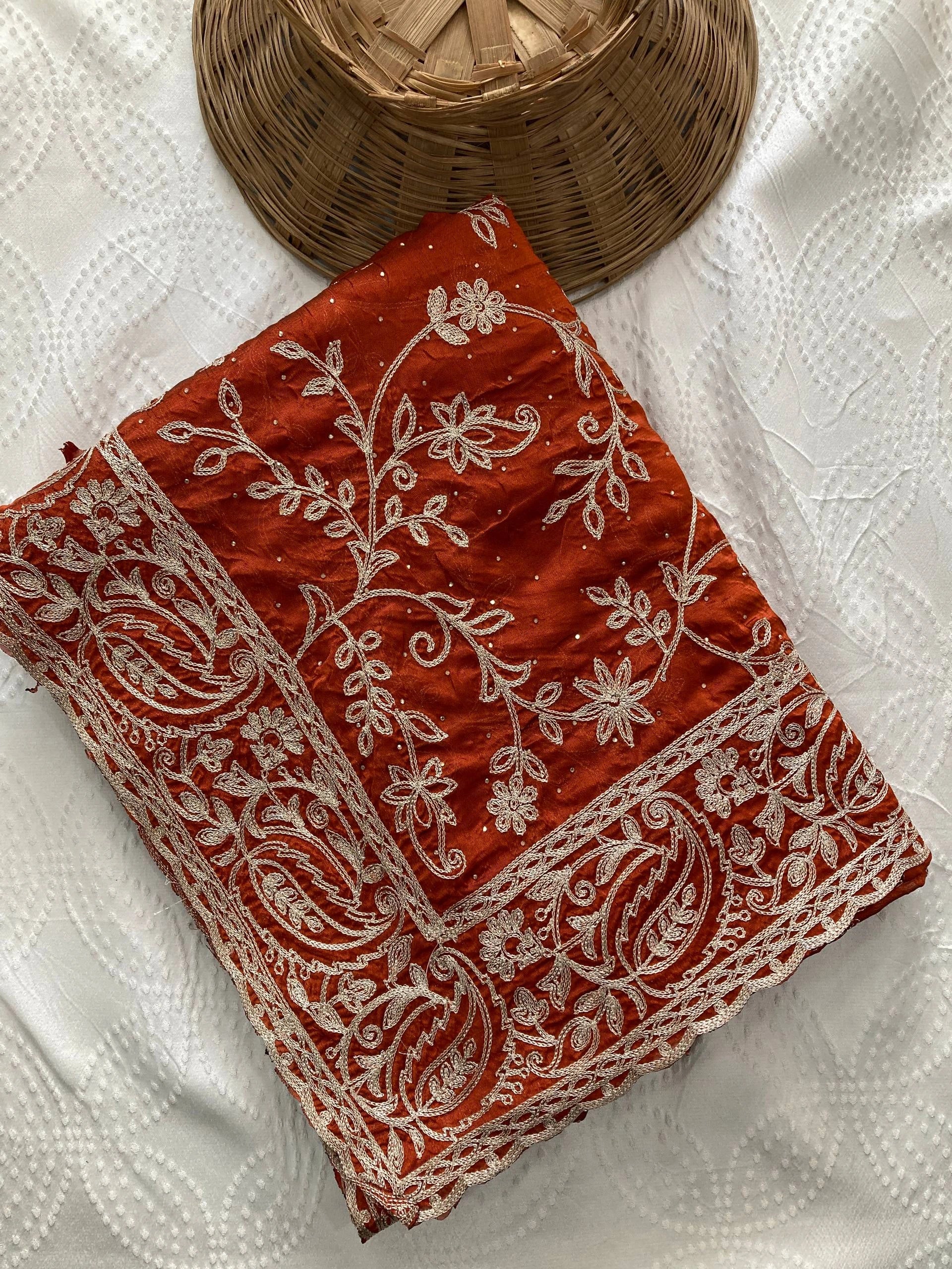 Red fabric with white embroidery on a white background