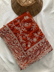Red fabric with white embroidery on a white background