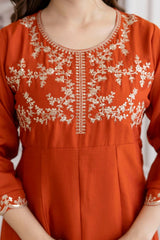 Orange kurta with white embroidery on a plain background