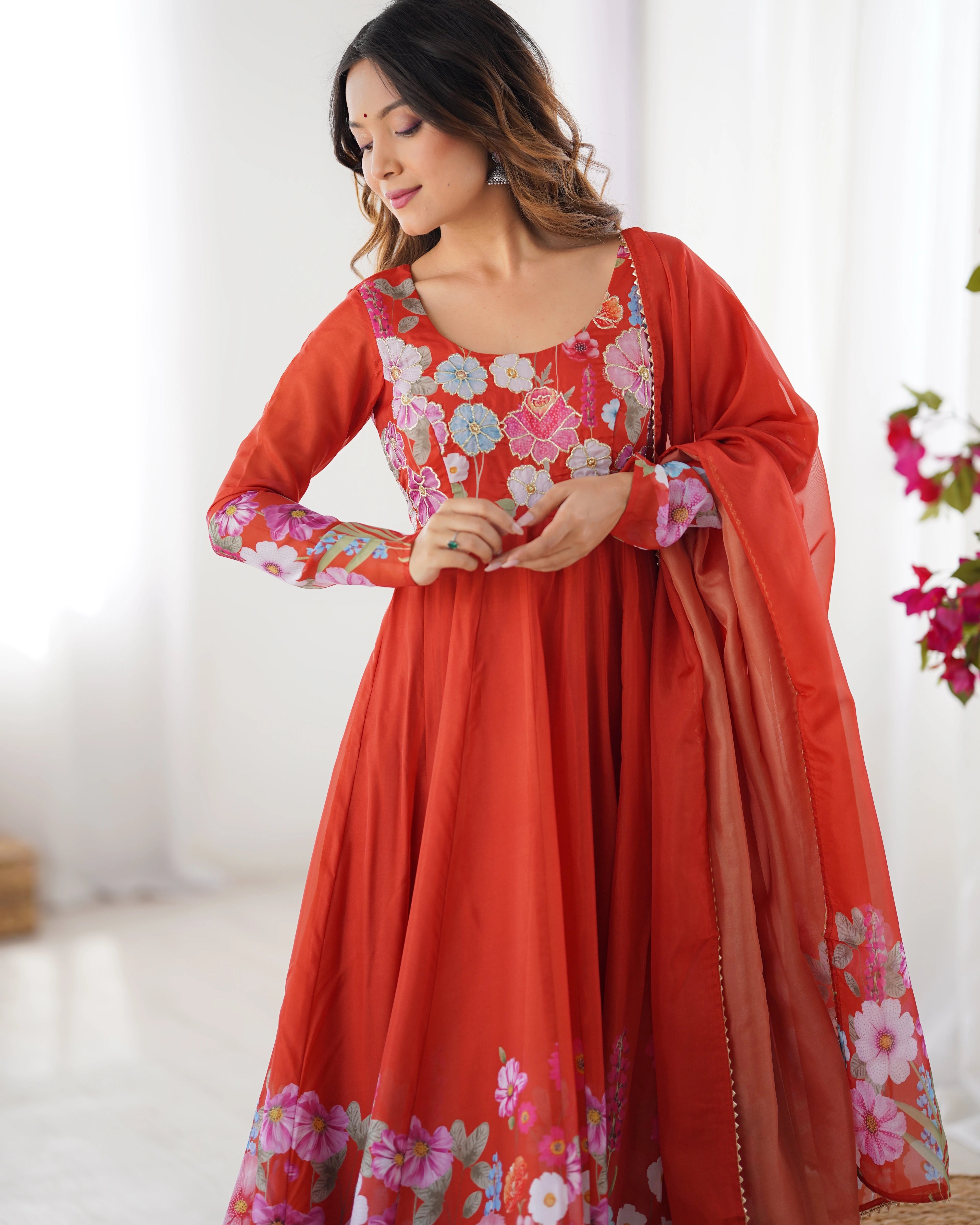 Woman wearing a red floral traditional outfit with a white background