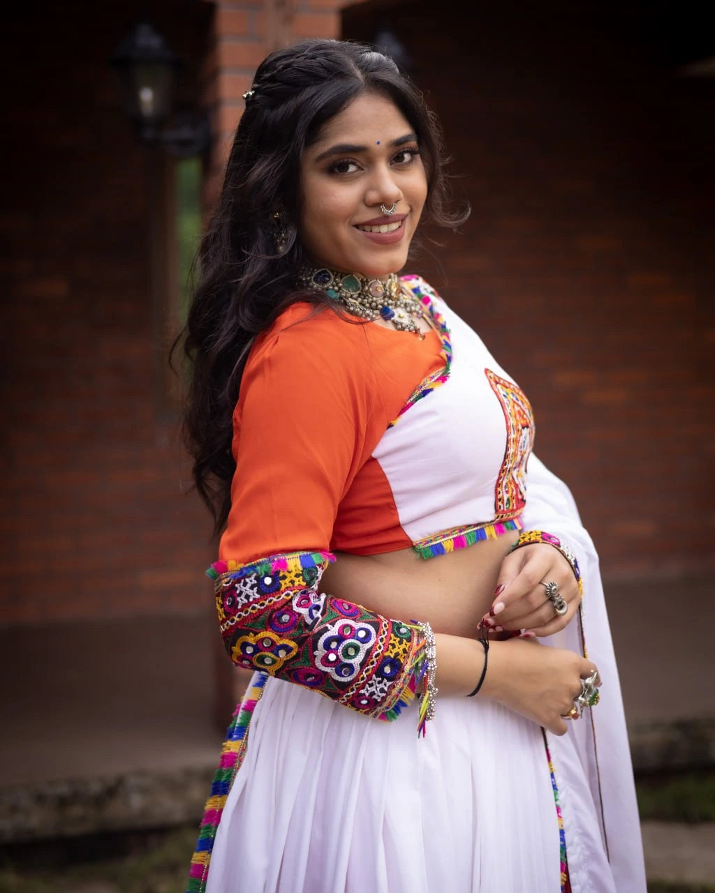 Woman wearing a colorful traditional outfit with a white background