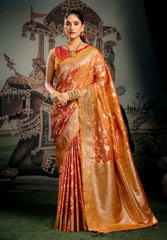 Woman in an orange saree with a traditional backdrop