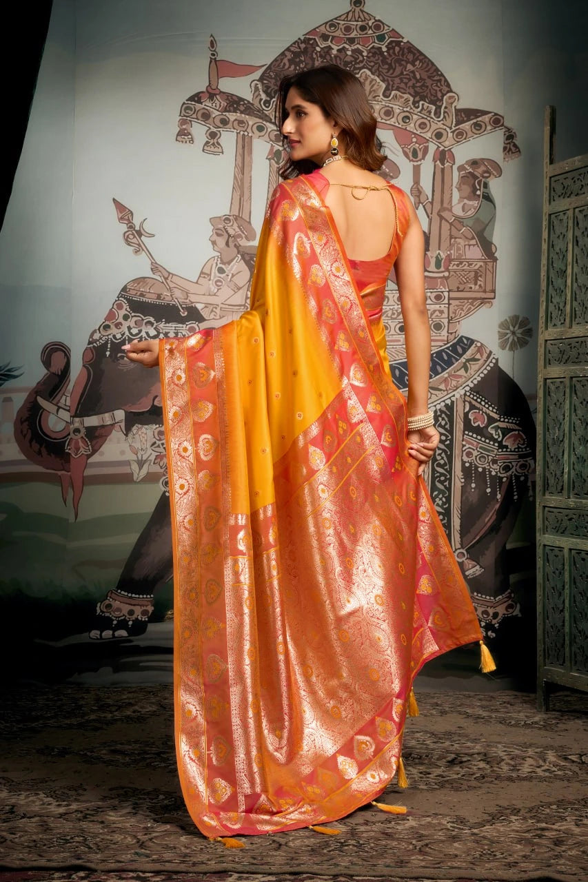 Woman in a vibrant orange and red saree with a decorative background