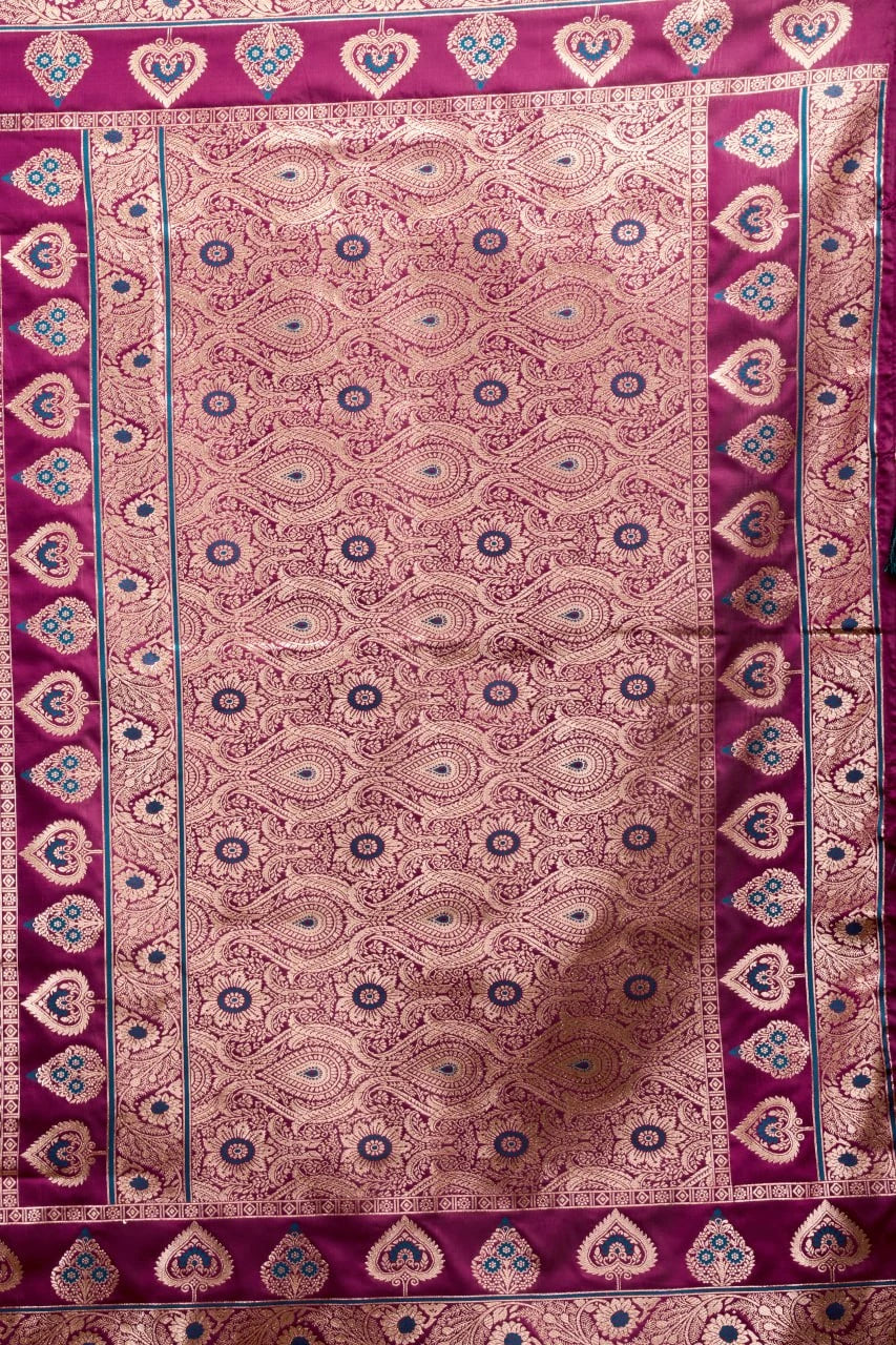 Decorative fabric with intricate paisley pattern on a purple background