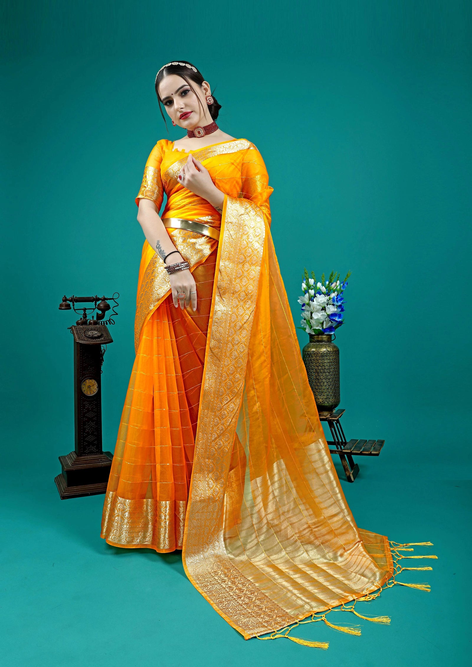 Stunning yellow saree with elegant golden zari woven border design