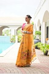 Woman in a yellow saree with pink blouse standing by a poolside.
