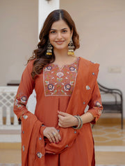 Woman wearing an orange embroidered traditional outfit with a blurred background