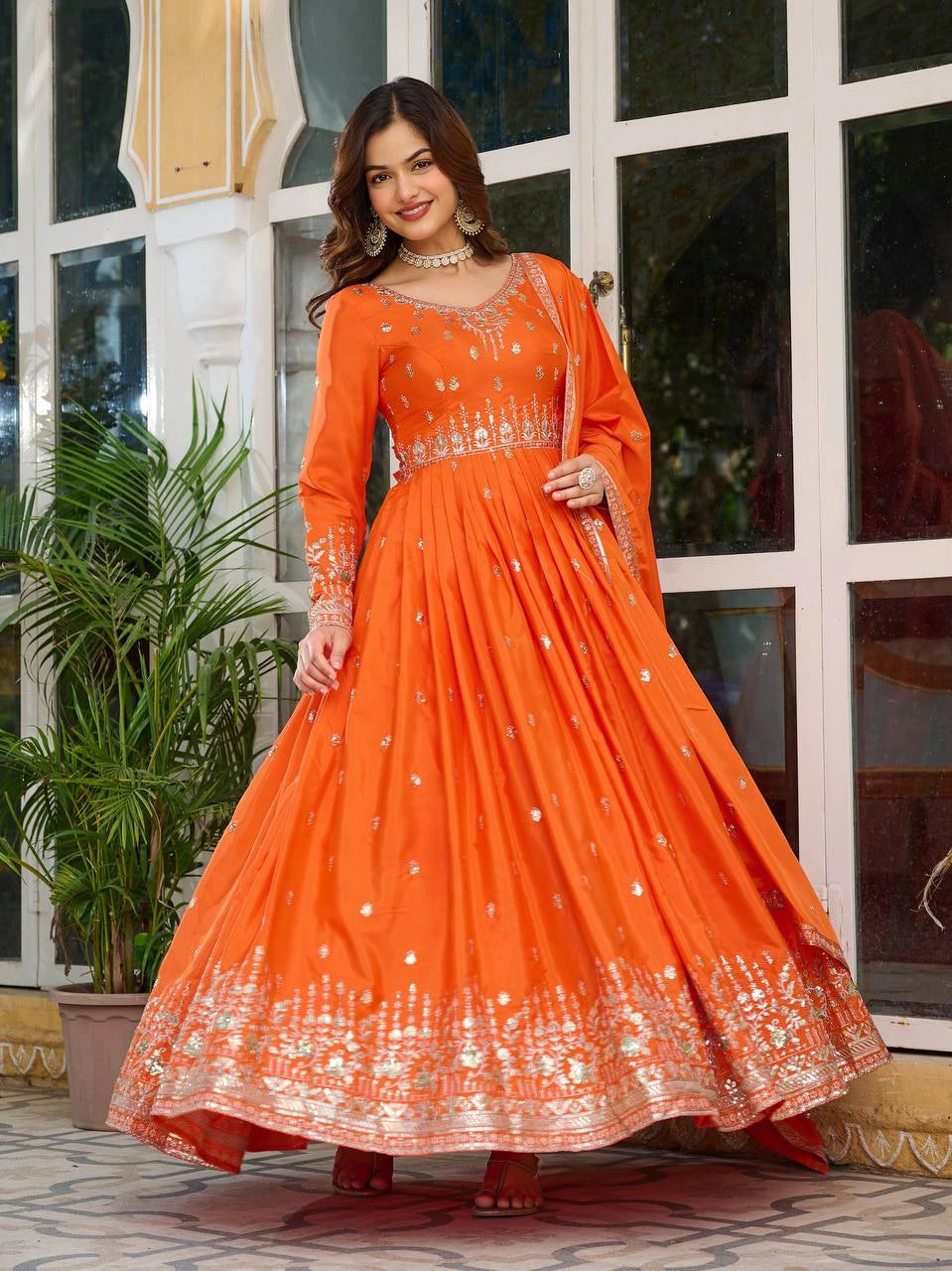 Luxurious orange silk suit featuring intricate sequins and thread work design.