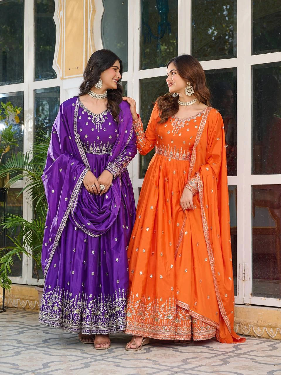 Festive orange silk suit with traditional sequins and thread embroidery design.