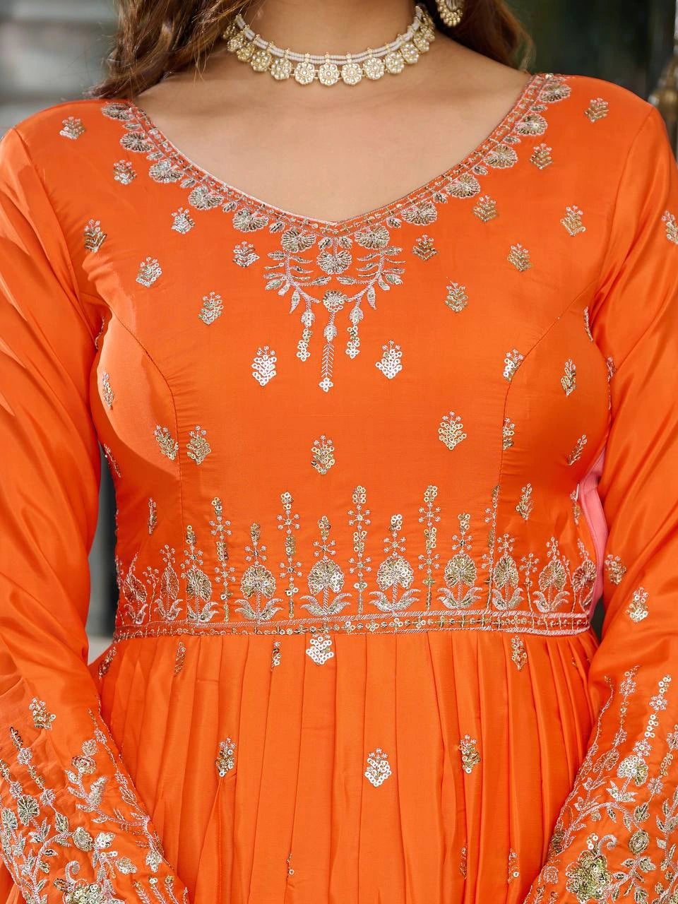 Bright orange American silk suit adorned with delicate sequins and thread patterns.