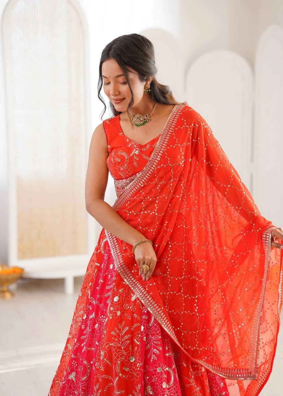 Woman wearing a bright red saree with white patterns in an indoor setting