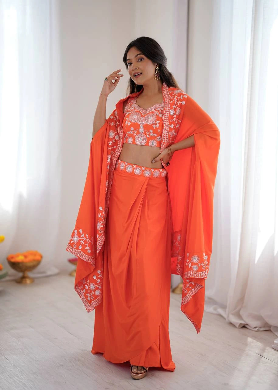 Woman wearing an orange traditional outfit with a white pattern in a bright room.
