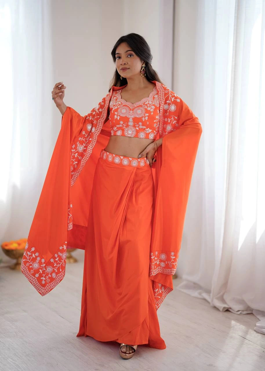 Woman wearing an orange traditional outfit with white patterns indoors.