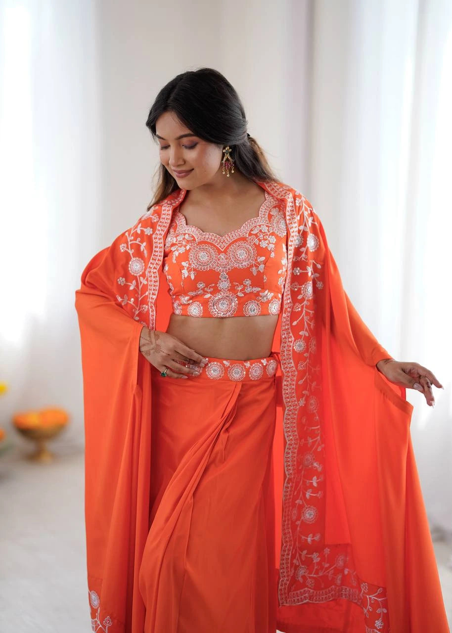 Woman wearing an orange traditional outfit with white embroidery against a light background