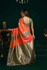 Woman in a traditional saree with a dark green background