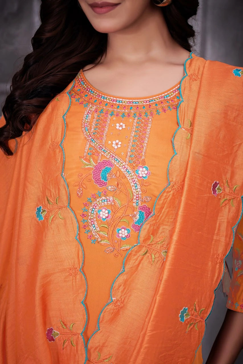 Close-up of an orange embroidered garment with a blurred background