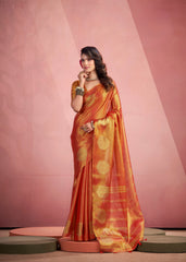 Woman wearing an orange saree with a pink background