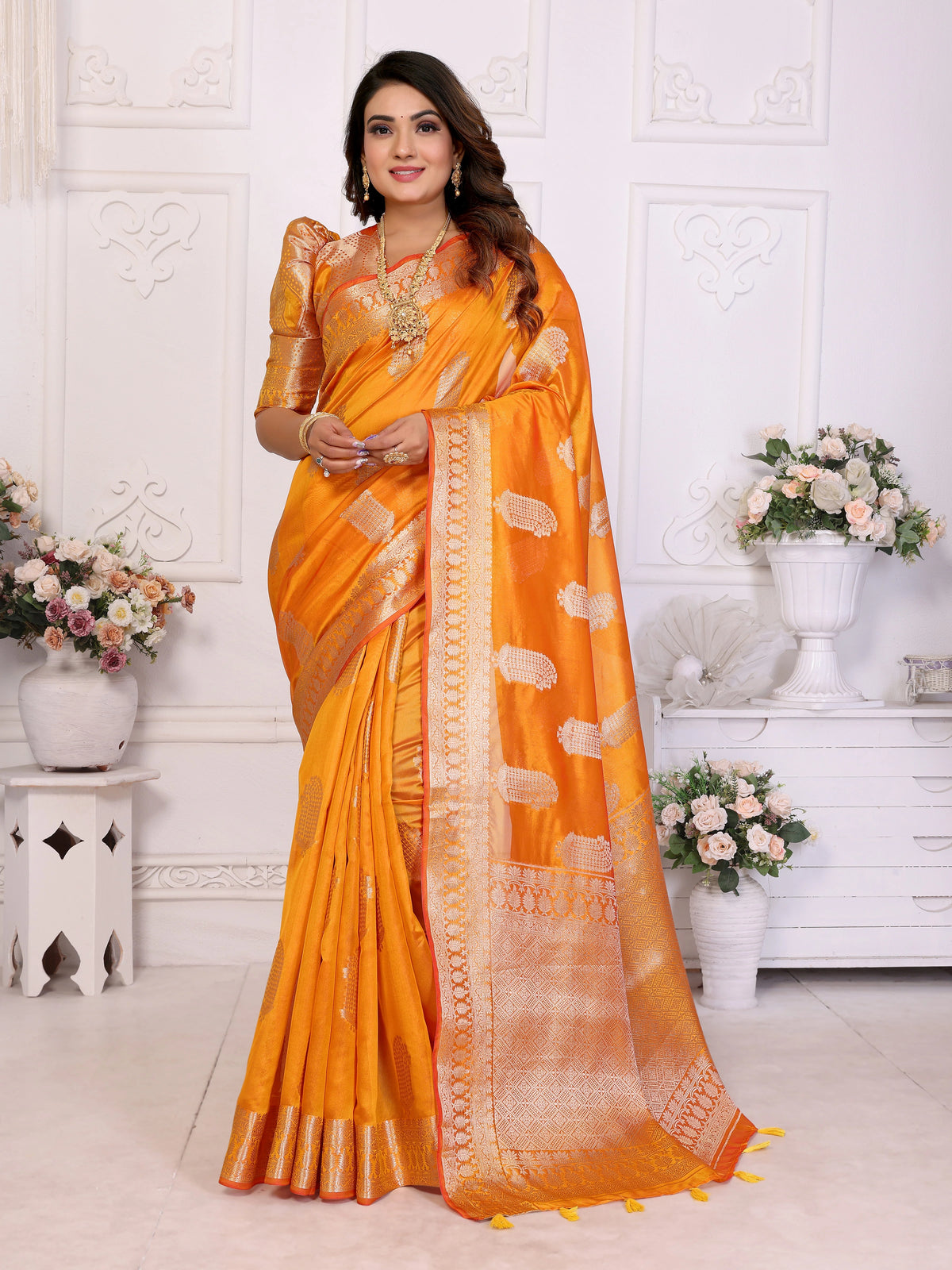 Woman wearing an orange saree with a white background