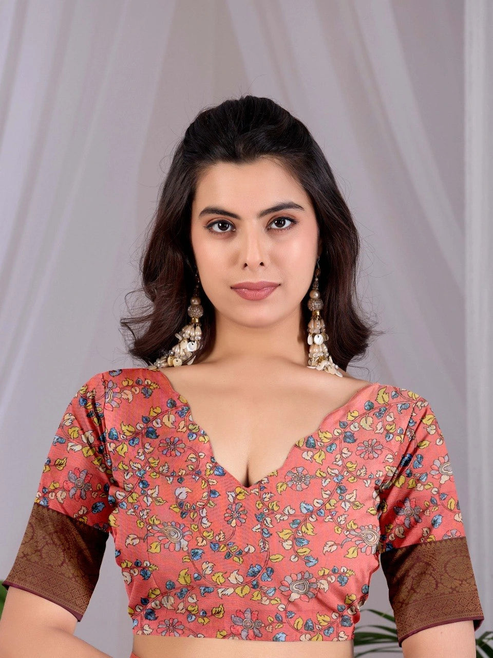 Woman wearing a floral blouse with a plain background