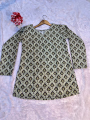 Green patterned shirt on a hanger against a light gray background