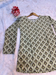 Patterned shirt on a hanger with a floral decoration on a light background