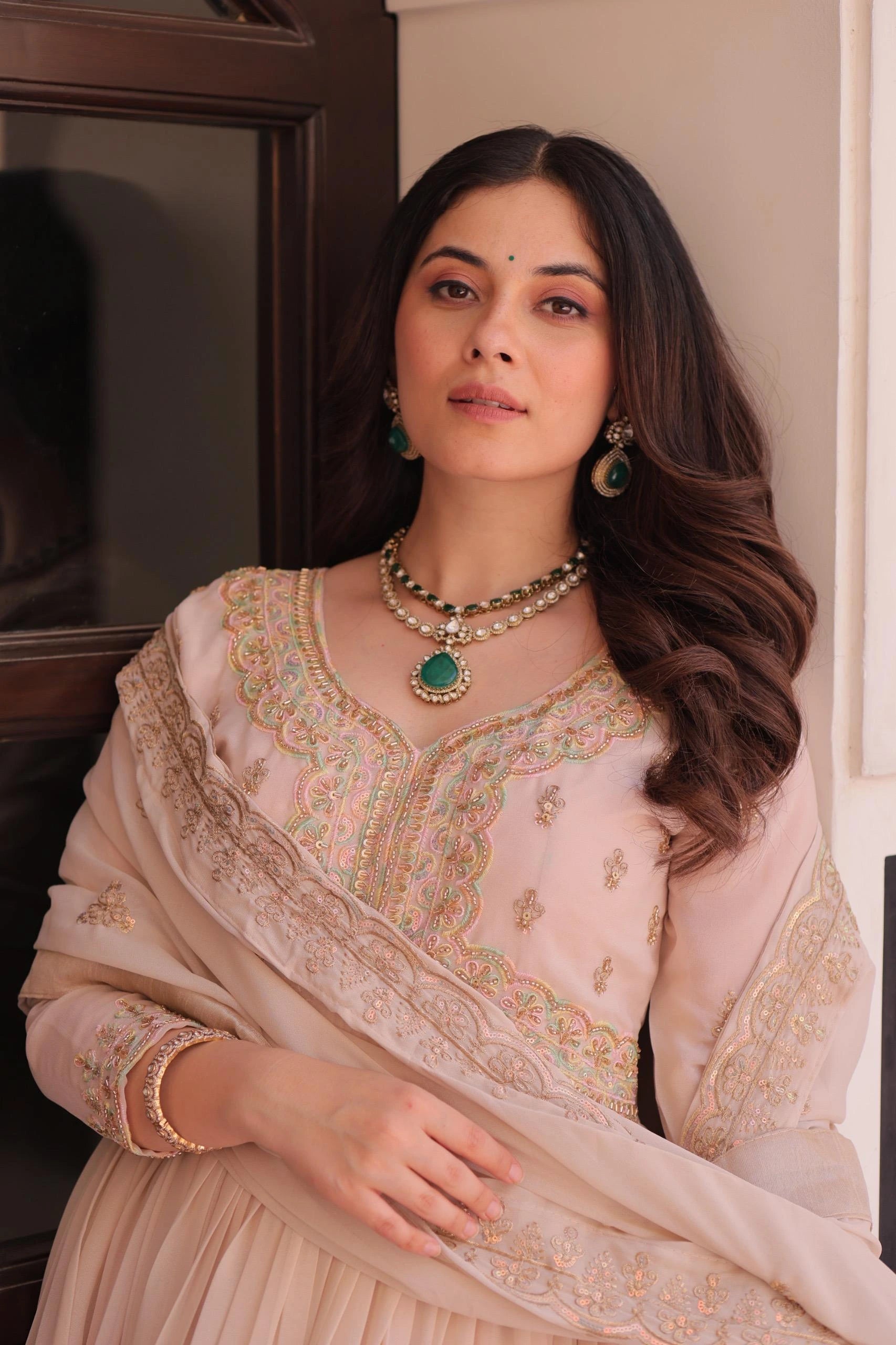 Woman in traditional attire with jewelry indoors