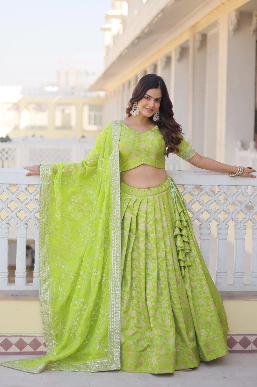 Woman in a green traditional outfit standing on a balcony.