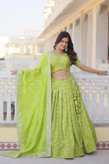 Woman in a green traditional outfit standing on a balcony.