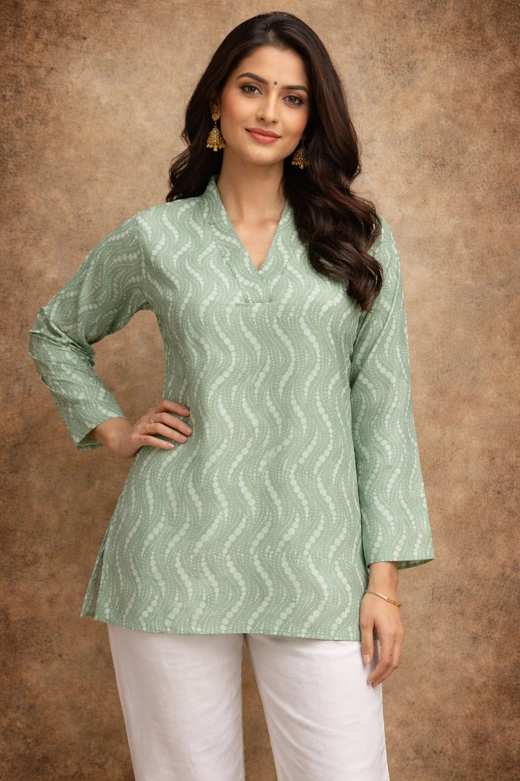 Woman wearing a green patterned top against a brown background