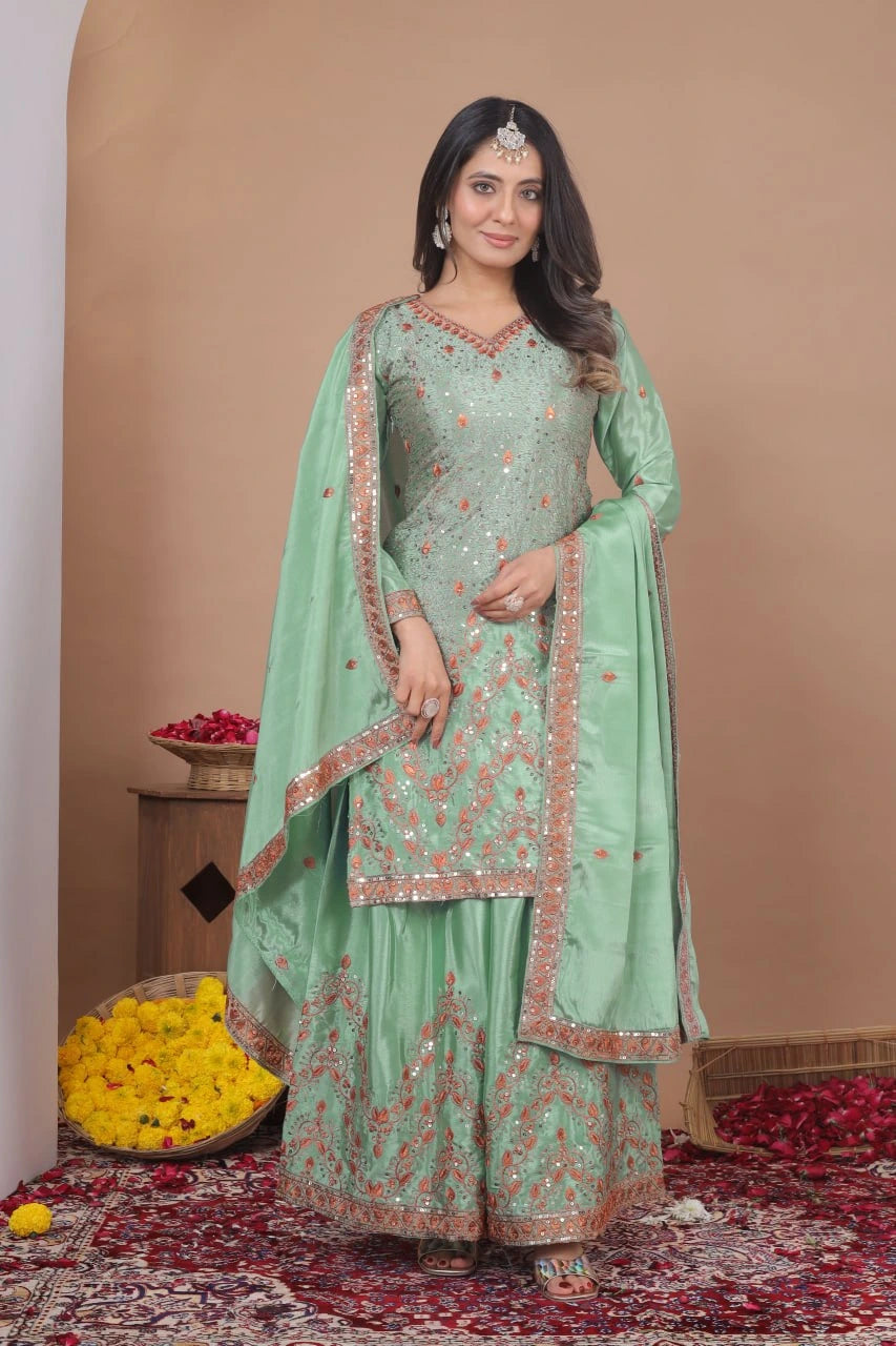 Woman in a light green traditional outfit with floral patterns on a beige background
