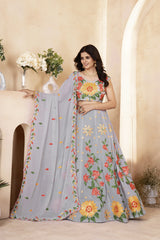 Woman wearing a floral saree with a neutral background