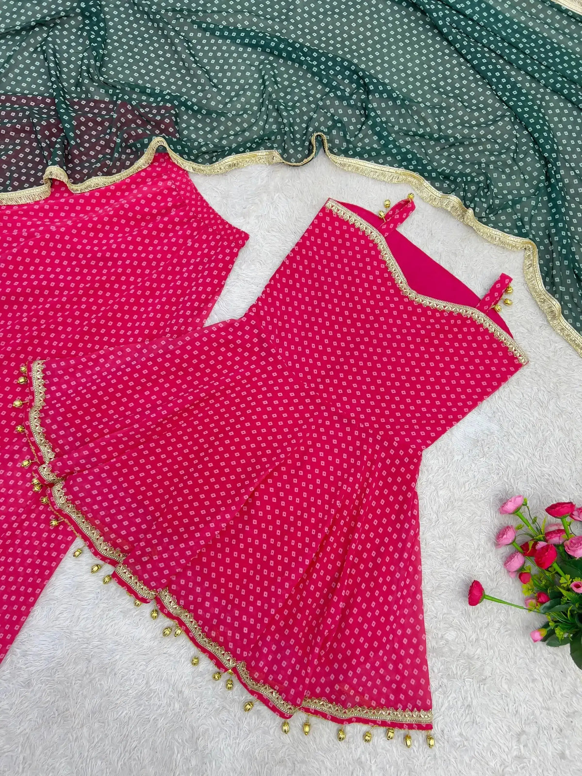 Flat lay close-up of Pink Bandhej Print Suit top and green dupatta detail
